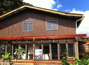 a house with a gambrel roof at Mile 36 Lodge in Kampong Kundassan