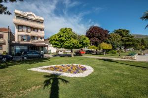 a circle of flowers in the grass in front of a building at Villa Darko - VIP Accomodations in Ohrid