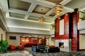 a lobby of a hotel with a fireplace at Chateau Nova Yellowhead in Edmonton