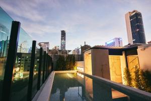a rooftop pool with a view of the city at Artino Hotel - SHA Extra Plus in Bangkok