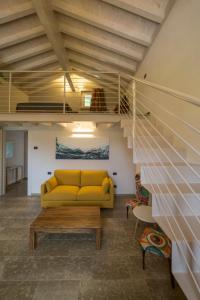 a living room filled with furniture and a stairway at Agriturismo Casarai in Zone