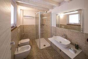 a bathroom with a toilet and a sink and a shower at Agriturismo Casarai in Zone