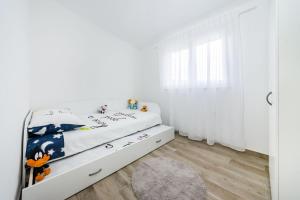 Posteľ alebo postele v izbe v ubytovaní Apartmani NEVA, Pridraga