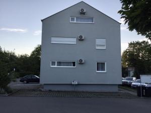 a white building with windows on the side of it at Outlet Apartments Metzingen in Metzingen