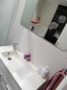 a bathroom with a white sink and a mirror at Gabi in Makarska