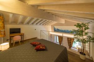 a living room with a bed and a tv at Agriturismo Casarai in Zone
