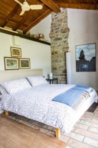 a bedroom with a bed and a stone wall at nido d'amore in Dernice