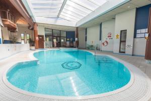 a large swimming pool in the middle of a building at Craigmonie Hotel Inverness by Compass Hospitality in Inverness
