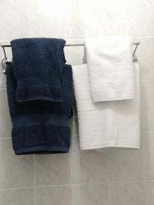 three towels on a towel rack in a bathroom at Arches B&B in St Austell