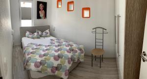 a bedroom with a bed and a chair and a ladder at Ferienhaus Pilse 3 in Erfurt