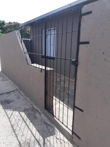 a metal gate on the side of a building at Roos Getaway Apartments #8 in Bela-Bela