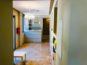 a hallway with a room with a table and a couch at Alexandrina in Mola Kalyva
