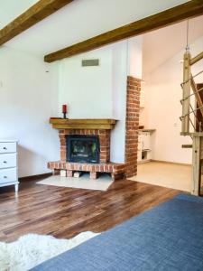 a living room with a brick fireplace in a house at Pod Klonem in Szczawnica