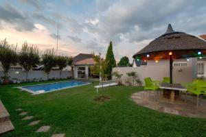 a backyard with a pool and a table and chairs at Angelica Guest House in Boksburg