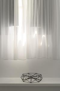a metal object sitting in front of a window at Antoperla Luxury Hotel & Spa in Perissa