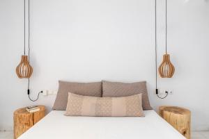 A bed or beds in a room at Ornos Blue