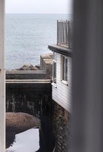 a building next to a body of water at Ammonite Luxury beachfront apartment in Lyme Regis