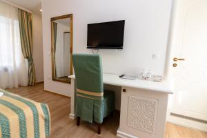 a room with a desk with a television and a chair at Citta Vecchia B&B in Krk