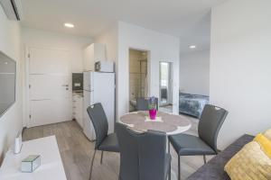 a kitchen and dining room with a table and chairs at VILA KIKA in Rogoznica