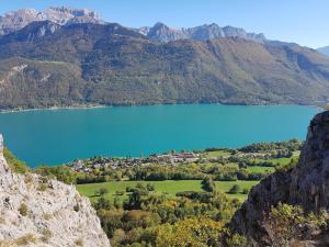 a view of a blue lake in the mountains at TISHA in Saint-Jorioz +30 photos