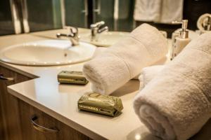 a bathroom with a sink and towels on a counter at Villa Marmari 1 in Marmarion +17 photos
