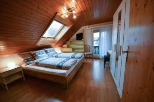 a bedroom with a bed with blue pillows on it at Pension Chalet Charme in Siebnen