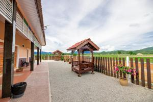 a porch of a house with a gazebo at D’ Village Cottage in Pantai Cenang