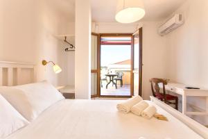 a bedroom with a bed with two towels on it at Sand'Ana House B&b in Alghero