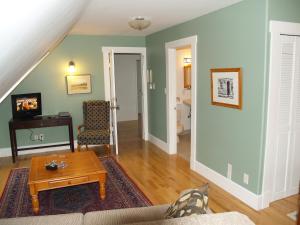 a living room with a couch and a table at Bakers Chest B&B in Truro