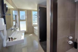 a bathroom with a toilet and a sink and a shower at Nelia Beach Hotel & Spa in Ayia Napa