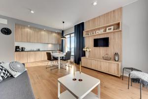 a living room with a couch and a table at Old Town Apartments Apartinfo in Gdańsk