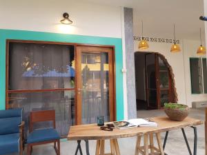 a wooden table sitting in front of a building at Lay Day in Khon Kaen