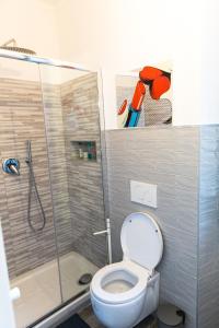 a bathroom with a toilet and a glass shower at La villetta dei sogni nel Parco in Rome +24 photos