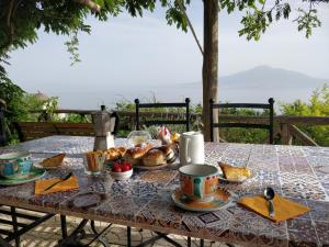 a table with a breakfast of bread and croissants at Giardino 21 Marzo in Vico Equense