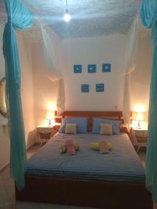 a bedroom with a blue bed with three pillows on it at Asprovalta Istos house in Asprovalta