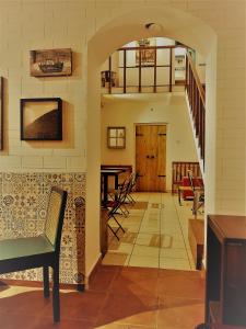 a living room with an archway and a table and chairs at The White Balcao in Panaji