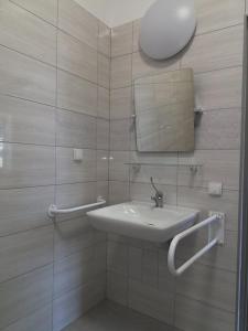 a bathroom with a sink and a mirror at Centrum Wypoczynkowe COMPLEX in Mąkoszyn