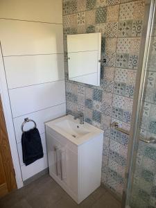 a bathroom with a sink and a mirror at Sealladh A’ Chaolais (Eriskay) in Eriskay