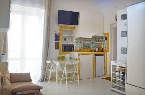 a kitchen with a table and a kitchen with a refrigerator at LA SCALINATELLA -vista mare- in Vietri sul Mare