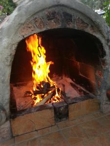 a brick oven with a fire in it at Apartments Kovačević in Petrovac na Moru