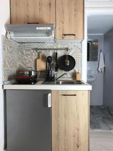 a kitchen with a sink and a stove top oven at stuDio 57 II in Alexandroupoli