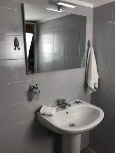 a white bathroom with a sink and a mirror at stuDio 57 II in Alexandroupoli +17 photos