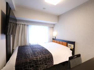 Vuode tai vuoteita majoituspaikassa APA Hotel Shinjuku Kabukicho Chuo