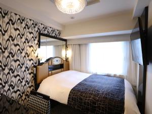 Vuode tai vuoteita majoituspaikassa APA Hotel Shinjuku Kabukicho Chuo