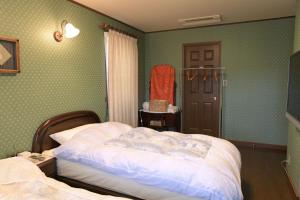 เตียงในห้องที่ Guesthouse Kizuna