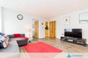 a living room with a couch and a flat screen tv at Hill Cottage Apartments Coleshill Open for NEC weekend visitors - Hosted By Coventry Accommodation in Coleshill