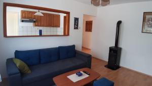 a living room with a blue couch and a table at Apartment Ivana in Gospić