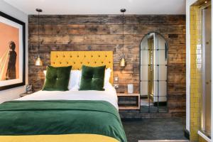 A bed or beds in a room at The Green Dragon Inn 