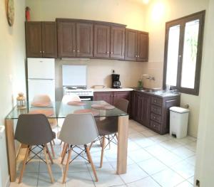 a kitchen with a glass table and chairs in a kitchen at Sweet Home (50m from center Lithostroto) in Argostoli