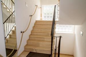 a staircase with wooden steps and a window at Ferienhaus Mühlenberg in Monschau